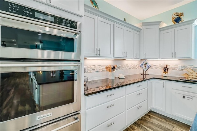 694 Kara Dr, Port Aransas, TX 78373 - kitchen with stainless steel double oven, a warming drawer, decorative backsplash, and dark stone counters