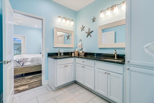 694 Kara Dr, Port Aransas, TX 78373 - full bathroom featuring double vanity, tile patterned floors, and ensuite bath