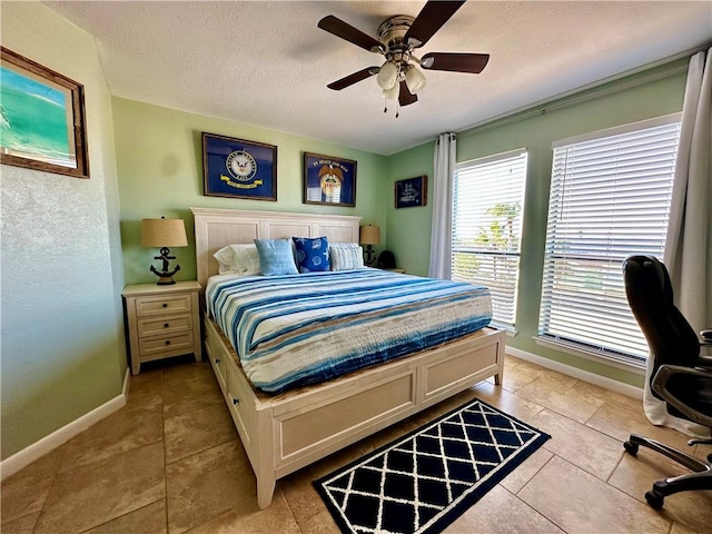 bedroom with light tile patterned floors, a textured ceiling, and ceiling fan