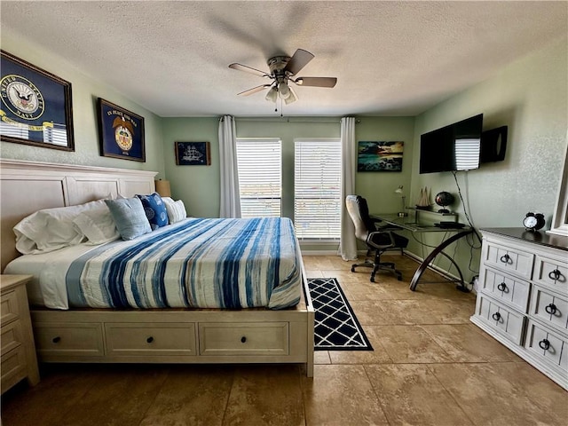 bedroom with a textured ceiling and ceiling fan