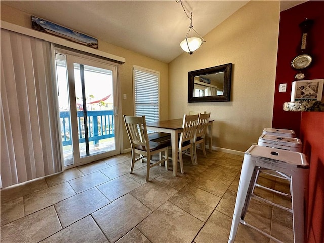 dining space with lofted ceiling