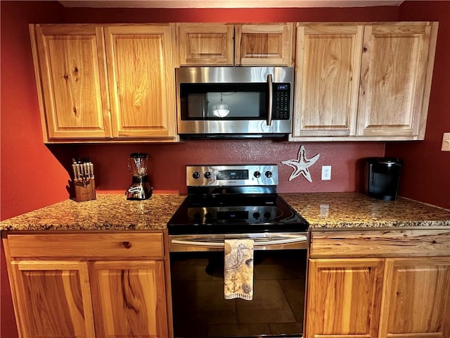 kitchen featuring stainless steel appliances and light stone countertops