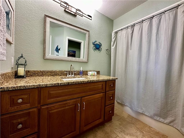 bathroom with vanity and a textured ceiling