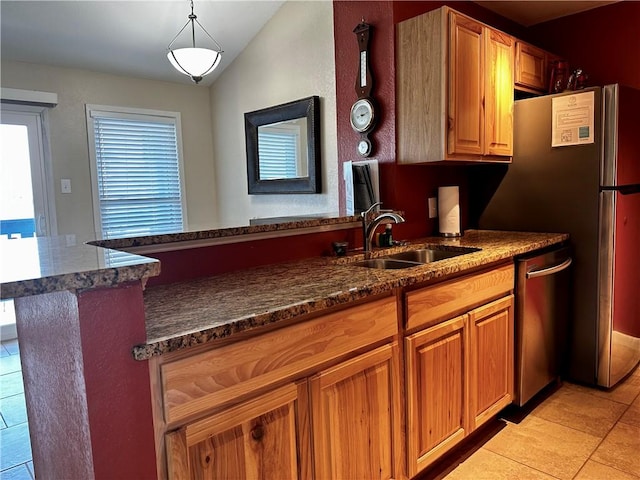 kitchen with dishwasher, lofted ceiling, sink, hanging light fixtures, and kitchen peninsula