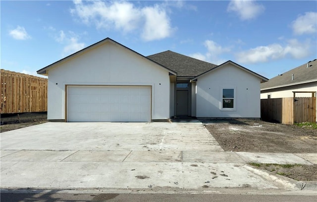 ranch-style home featuring fence, a garage, driveway, and stucco siding