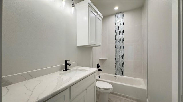 bathroom featuring toilet, vanity, and bathtub / shower combination