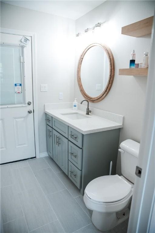 bathroom with tile patterned floors, vanity, and toilet