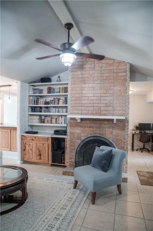 living room featuring a fireplace, vaulted ceiling with beams, ceiling fan, and light tile patterned floors