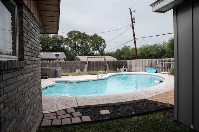 view of swimming pool with a fenced in pool, a hot tub, and a fenced backyard