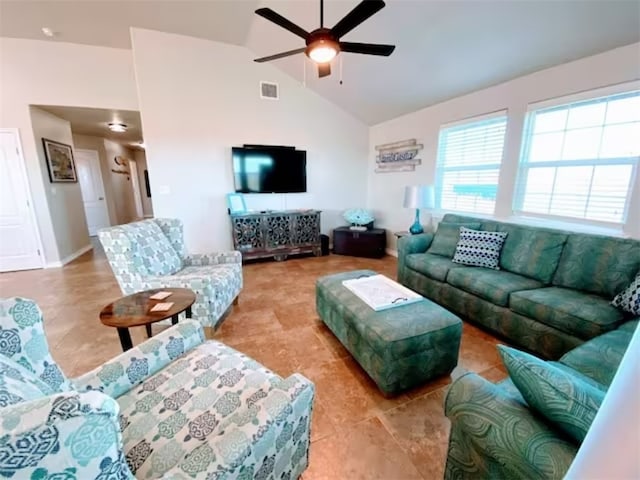 tiled living room featuring high vaulted ceiling and ceiling fan