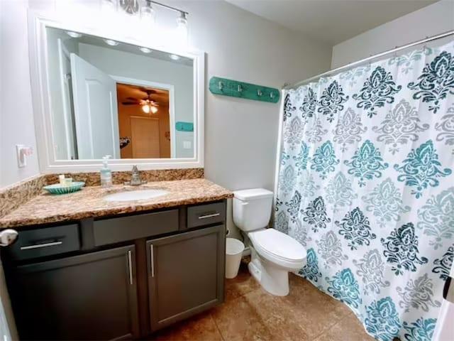 bathroom with toilet, vanity, tile patterned floors, and ceiling fan