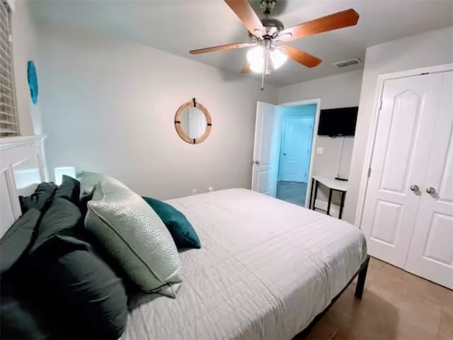 bedroom featuring ceiling fan and light colored carpet