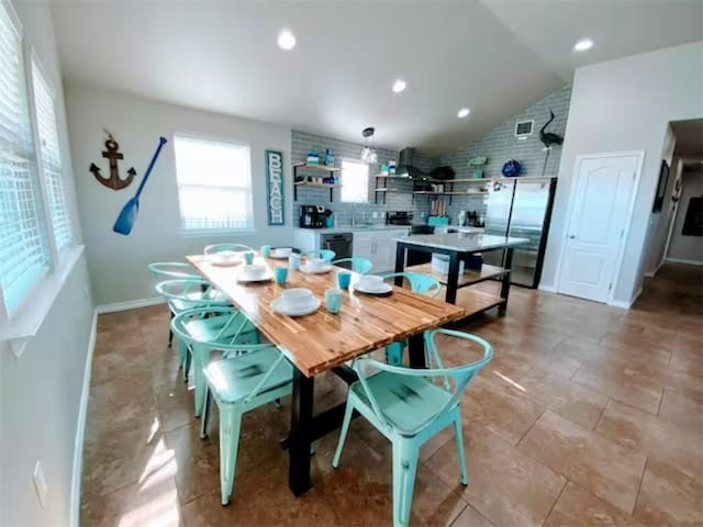 dining space with lofted ceiling