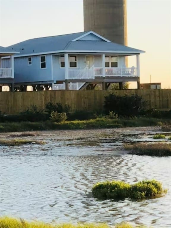 back house at dusk with a water view