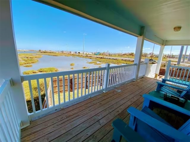 wooden deck featuring a water view