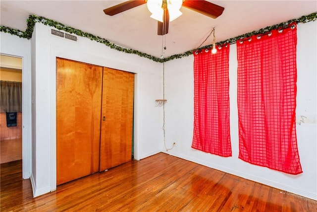 4114 Markins Dr, Corpus Christi, TX 78411 - unfurnished bedroom with wood finished floors, a closet, and a ceiling fan