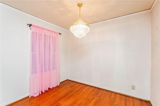 4114 Markins Dr, Corpus Christi, TX 78411 - spare room featuring a chandelier, wood finished floors, and ornamental molding