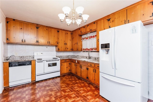 4114 Markins Dr, Corpus Christi, TX 78411 - kitchen featuring white appliances, a chandelier, and brown cabinets