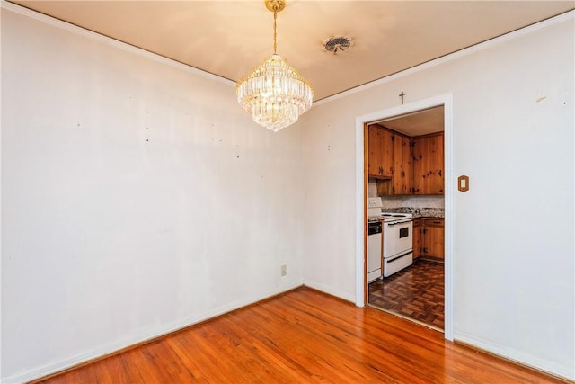 4114 Markins Dr, Corpus Christi, TX 78411 - unfurnished dining area with a chandelier, wood finished floors, and crown molding