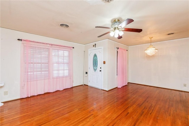4114 Markins Dr, Corpus Christi, TX 78411 - unfurnished room with a ceiling fan, light wood-style floors, and a chandelier