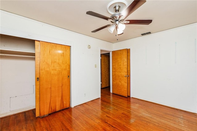 4114 Markins Dr, Corpus Christi, TX 78411 - unfurnished bedroom with wood finished floors, a closet, and ceiling fan
