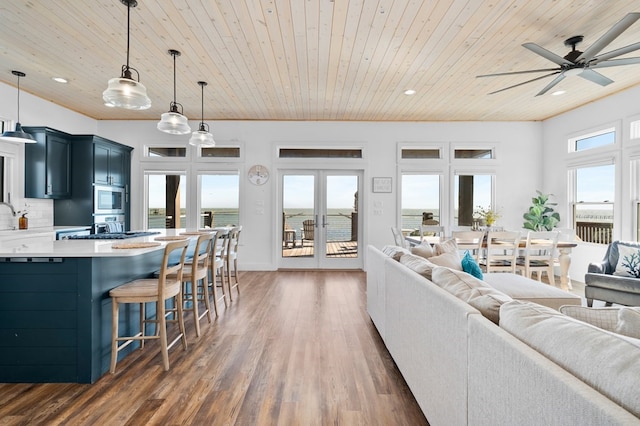 living room with wood ceiling, a water view, ceiling fan, french doors, and dark hardwood / wood-style floors