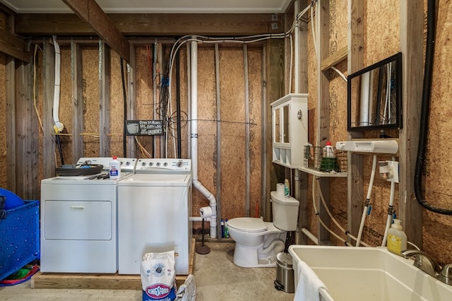 washroom with washing machine and clothes dryer and sink