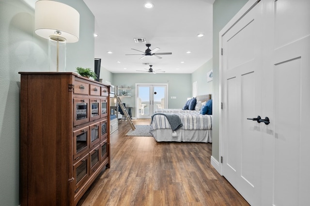 bedroom with french doors and dark hardwood / wood-style flooring