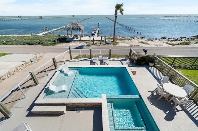 view of pool with a patio, a water view, and a gazebo