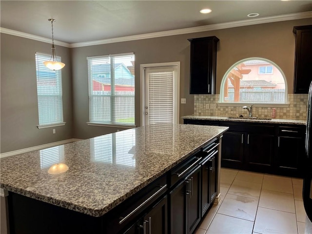 2212 Tallow Dr, Portland, TX 78374 - kitchen with a sink, light stone countertops, tasteful backsplash, and crown molding