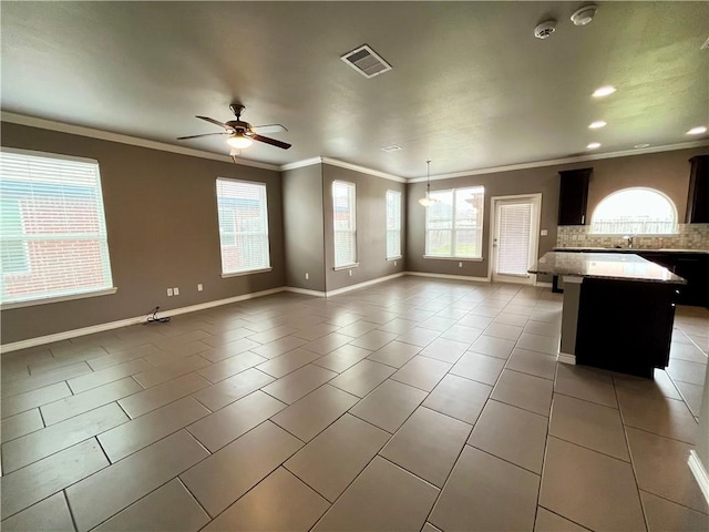 unfurnished living room featuring light tile patterned floors, a ceiling fan, visible vents, and a healthy amount of sunlight