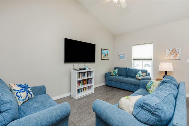 living room featuring high vaulted ceiling, wood finished floors, a ceiling fan, and baseboards