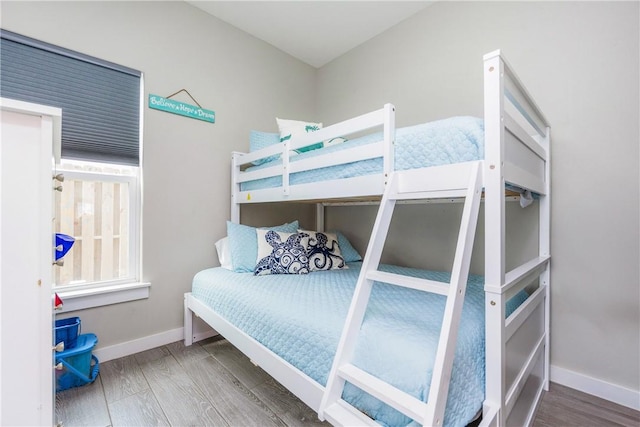 bedroom featuring baseboards and wood finished floors