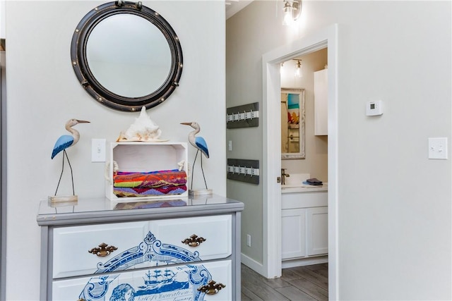 bathroom with vanity, baseboards, and wood finished floors