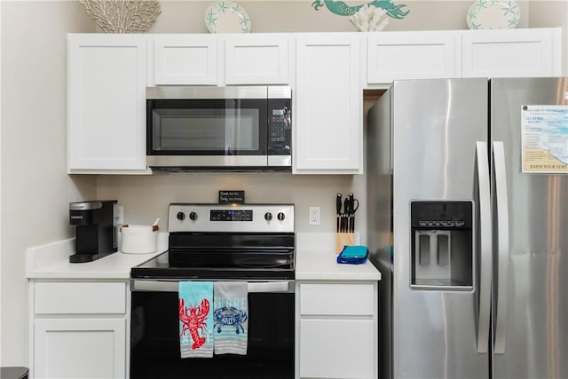 kitchen featuring white cabinets, appliances with stainless steel finishes, and light countertops