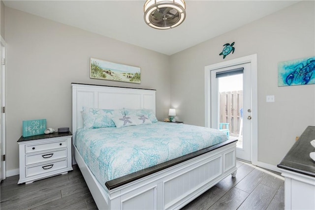 bedroom featuring access to outside, baseboards, and dark wood-type flooring