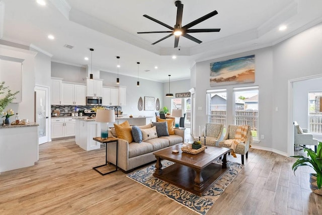 5810 Bella Di Giorno Dr, Corpus Christi, TX 78414 - living room with a raised ceiling, light wood-style floors, ceiling fan, recessed lighting, and ornamental molding