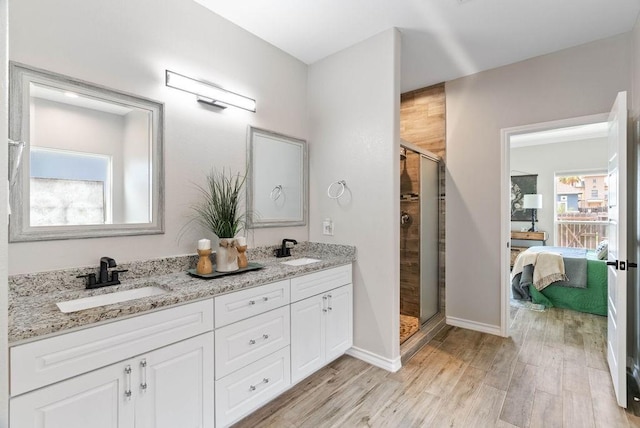 5810 Bella Di Giorno Dr, Corpus Christi, TX 78414 - ensuite bathroom featuring a shower stall, double vanity, and wood finished floors
