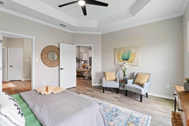5810 Bella Di Giorno Dr, Corpus Christi, TX 78414 - bedroom featuring light wood finished floors, a tray ceiling, crown molding, and ceiling fan