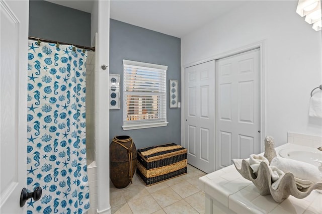 bathroom with tile patterned flooring, vanity, and curtained shower