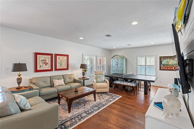 living room featuring dark hardwood / wood-style flooring and plenty of natural light