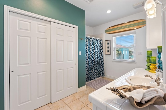 bathroom featuring tile patterned flooring, a shower with curtain, and vanity