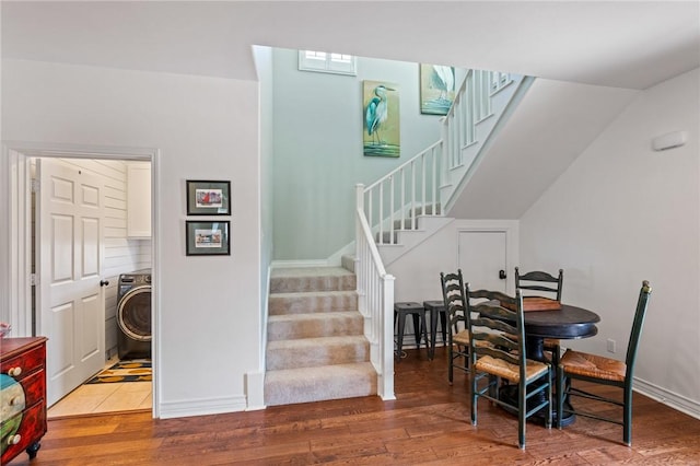 dining room with wood-type flooring and washer / clothes dryer