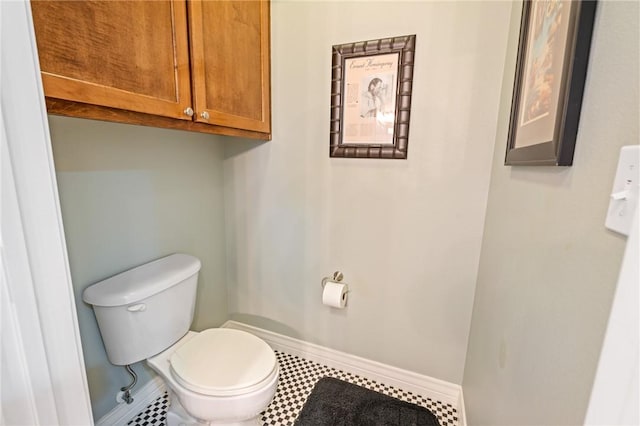 bathroom with tile patterned flooring and toilet