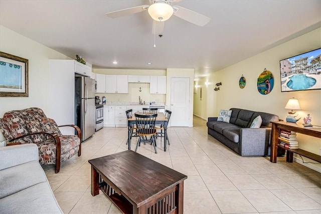 living area featuring light tile patterned floors and ceiling fan