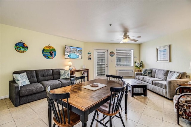 dining area featuring light tile patterned floors, an AC wall unit, and ceiling fan