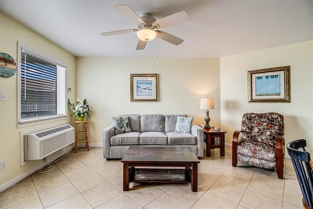 living room with light tile patterned floors, baseboards, a ceiling fan, and a wall unit AC