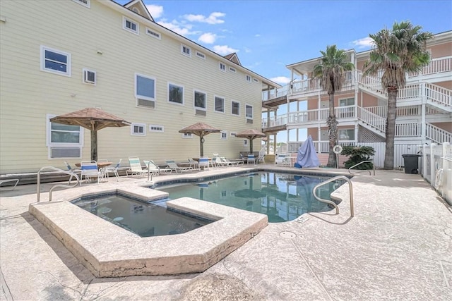 view of pool featuring a patio and a pool with connected hot tub