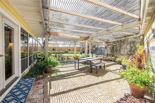 view of patio featuring fence, outdoor dining area, and a pergola