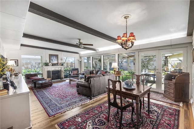 interior space with a wealth of natural light, french doors, a fireplace, and beamed ceiling